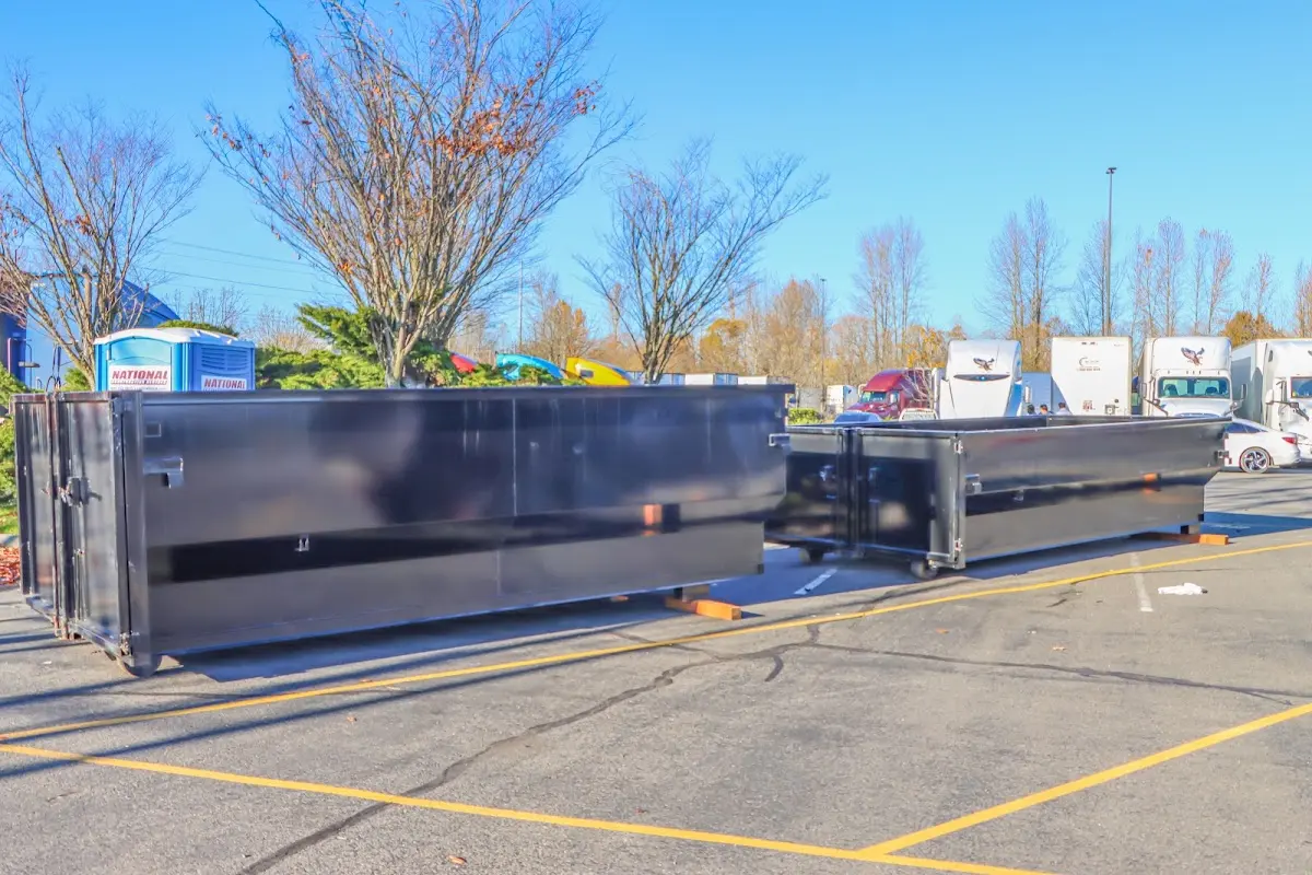Professional dumpster rental service with roll-off container on residential driveway in Clemson University